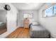 Simple bedroom with hardwood floors, single bed, dresser, and natural light from the window at 935 S Pecos Way, Denver, CO 80223
