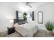 Bright bedroom with a ceiling fan, comfortable bed, and a decorative mirror and plants at 935 S Pecos Way, Denver, CO 80223