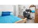 Well-lit bedroom offering a single bed with blue bedding and a dedicated study area at 935 S Pecos Way, Denver, CO 80223