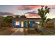 Charming blue single-story home with a well-maintained front yard and unique covered parking at 935 S Pecos Way, Denver, CO 80223
