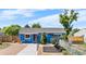 Charming blue single-story home with a well-maintained front yard and unique covered parking at 935 S Pecos Way, Denver, CO 80223