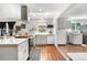 Bright kitchen featuring modern appliances, white cabinets, and a convenient laundry area at 935 S Pecos Way, Denver, CO 80223