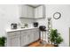 Clean kitchen with a modern look featuring grey cabinets and stainless steel appliances at 935 S Pecos Way, Denver, CO 80223