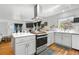 Stylish kitchen with a center island, modern appliances, and an open layout into the living area at 935 S Pecos Way, Denver, CO 80223