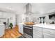 Spacious kitchen with modern appliances, a central island, and an open view to the living room at 935 S Pecos Way, Denver, CO 80223