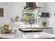 Bright kitchen with modern appliances, stone countertops, and decorative plants by the window at 935 S Pecos Way, Denver, CO 80223