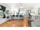 Bright living room featuring an open floor plan, wood floors and a kitchen island with barstool seating at 935 S Pecos Way, Denver, CO 80223