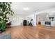 Spacious living room with hardwood floors, home office setup, and a modern kitchen view at 935 S Pecos Way, Denver, CO 80223