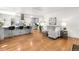 Open concept living room and kitchen area features hardwood floors and modern decor at 935 S Pecos Way, Denver, CO 80223