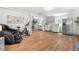 Bright living area with exercise equipment, stainless steel refrigerator, and modern laundry setup at 935 S Pecos Way, Denver, CO 80223