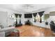 Well-lit living room with hardwood floors, a comfortable seating area, and stylish decor at 935 S Pecos Way, Denver, CO 80223