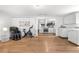 Open-concept space featuring an exercise area, laundry appliances, and stylish flooring at 935 S Pecos Way, Denver, CO 80223