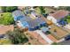 Aerial view of a blue single-story home featuring a spacious backyard, basketball court, and detached garage at 935 S Pecos Way, Denver, CO 80223
