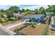 Blue single-story home with a well-maintained yard and unique covered parking, basketball court and garden at 935 S Pecos Way, Denver, CO 80223