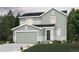 Charming two-story home with a gray exterior, attached garage, and manicured front lawn at 4275 Gozzer Ranch Dr, Elizabeth, CO 80107