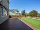 Backyard featuring a well-maintained lawn, wooden fence, and stamped concrete patio at 5369 Creek Way, Parker, CO 80134