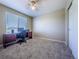 Well-lit bedroom with a large window, plush carpeting, desk with PC, and a ceiling fan at 5369 Creek Way, Parker, CO 80134