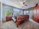 Comfortable bedroom featuring a ceiling fan, ample natural light, and stylish furnishings at 5369 Creek Way, Parker, CO 80134