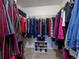 Walk-in closet with ample storage space, organized clothing racks, shelving, and neutral carpeting at 5369 Creek Way, Parker, CO 80134