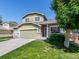 Charming two-story home featuring a well-manicured lawn, attached garage, and inviting front porch with flower boxes at 5369 Creek Way, Parker, CO 80134