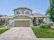 Charming two-story home featuring a well-manicured lawn, attached garage, and inviting front porch at 5369 Creek Way, Parker, CO 80134