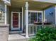 Inviting front porch adorned with vibrant flower boxes, offering a cozy and charming entrance to the home at 5369 Creek Way, Parker, CO 80134