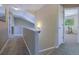 Upstairs hallway with carpet flooring leads to a bedroom with exercise equipment at 5369 Creek Way, Parker, CO 80134