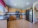 Bright kitchen features stainless steel appliances, wood cabinets, and modern fixtures, perfect for cooking and entertaining at 5369 Creek Way, Parker, CO 80134
