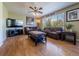 Bright and airy living room with ceiling fan, and large window with views of the outdoor landscape at 5369 Creek Way, Parker, CO 80134