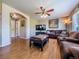 Relaxing living room with a large TV, comfortable seating, and neutral color palette at 5369 Creek Way, Parker, CO 80134