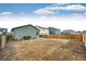 Large backyard features wood fencing, a concrete patio with grill, and ample space for outdoor activities at 316 Maple St, Bennett, CO 80102