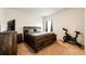 Cozy bedroom featuring a rustic wood bed frame and a decorative bicycle for exercise at 316 Maple St, Bennett, CO 80102