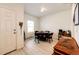Bright dining room featuring wood floors, round table with black chairs, and natural light at 316 Maple St, Bennett, CO 80102