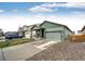 Charming home featuring a covered porch, two-car garage and adjacent home at 316 Maple St, Bennett, CO 80102
