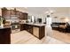 Modern kitchen featuring granite countertops, stainless steel appliances, and dark wood cabinets at 316 Maple St, Bennett, CO 80102
