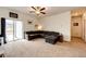Bright living room offering a large sectional sofa and sliding glass doors to the backyard at 316 Maple St, Bennett, CO 80102