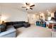 Open-concept living space with a sectional sofa and a partial view of the kitchen area at 316 Maple St, Bennett, CO 80102