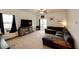 Spacious living room featuring neutral carpeting and a comfortable, oversized sectional sofa at 316 Maple St, Bennett, CO 80102