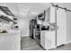 Modern kitchen with white cabinets, stainless steel appliances, and stylish backsplash at 3331 S Monaco Pkwy # C, Denver, CO 80222