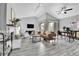 Bright living room with vaulted ceilings, modern furniture, fireplace, and sliding glass doors to a balcony at 3331 S Monaco Pkwy # C, Denver, CO 80222