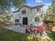 Exterior home view of a two-story house with a backyard patio, lounge furniture, and well-maintained lawn at 9816 S Holland St, Littleton, CO 80127