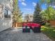 Inviting backyard patio with comfortable seating area, mature trees, and privacy fence at 9816 S Holland St, Littleton, CO 80127