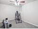 Finished basement showcasing fitness equipment, including a rowing machine, with neutral carpet and lighting at 9816 S Holland St, Littleton, CO 80127