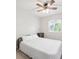 Inviting bedroom with a queen-sized bed, bedside table, and a ceiling fan creating a relaxing retreat at 9816 S Holland St, Littleton, CO 80127