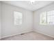 A bedroom with two windows to let the natural light in, and neutral colors offers a serene, calming atmosphere at 9816 S Holland St, Littleton, CO 80127
