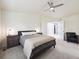 A serene bedroom features a comfortable queen-sized bed and two nightstands, complemented by an inviting chair at 9816 S Holland St, Littleton, CO 80127
