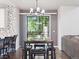 Dining area with seating for four, contemporary lighting, and views to the backyard at 9816 S Holland St, Littleton, CO 80127