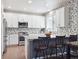 Modern kitchen featuring stainless steel appliances, white cabinets, and mosaic backsplash at 9816 S Holland St, Littleton, CO 80127