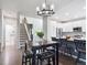Open concept kitchen with seating for four, white cabinetry, and island sink at 9816 S Holland St, Littleton, CO 80127
