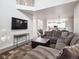 Open concept living room flowing into kitchen and dining area, with plush sectional sofa at 9816 S Holland St, Littleton, CO 80127